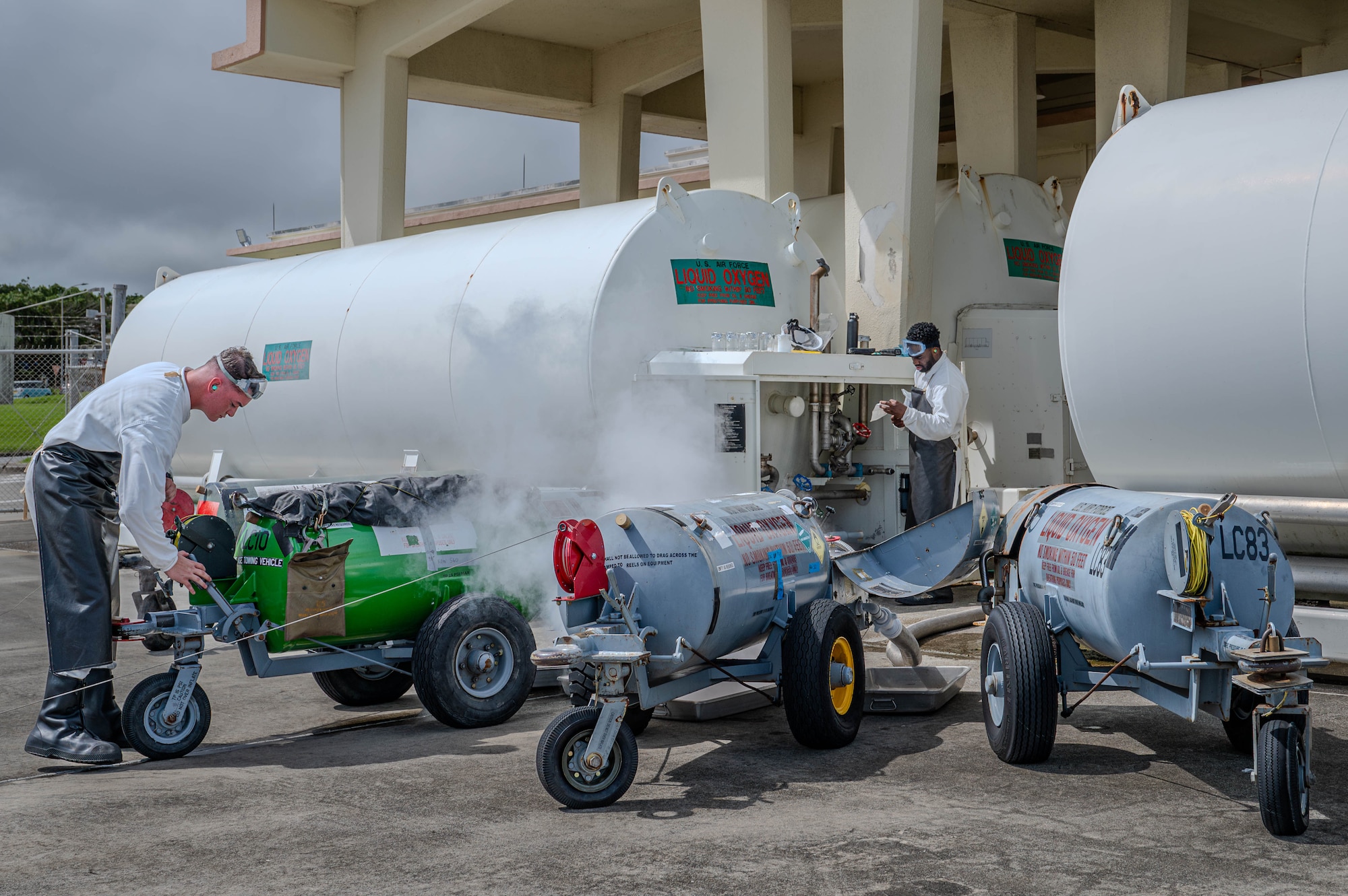 U.S. Marine Corps Lance Cpl. Michael Mallette, left, 9th Engineer Support Battalion fuel technician, and U.S. Air Force Airman 1st Class Dayton Clayton, 18th Logistic Readiness Squadron fuels facility technician, extract liquid oxygen from an oxygen cart.