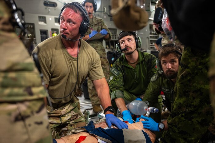 U.S. Air Force and Royal Canadian Air Force aeromedical evacuation members participate in a familiarization training on a U.S. Air Force C-17 Globemaster III aircraft assigned to the 60th Air Mobility Wing, during the Air Force's 2025 Department-Level Exercise series at Andersen Air Force Base, Guam, July 13, 2025. This exercise is part of the first-in-a-generation DLE series, a new way of conducting operations in a contested, dynamic environment to build capabilities making a stronger, more deterrent force. The DLE series encompasses all branches of the Department of Defense, along with Allies and partners, employing more than 400 Joint and coalition aircraft and more than 12,000 members at more than 50 locations across 3,000 miles. (U.S. Air Force photo by Senior Airman Brooklyn Golightly)