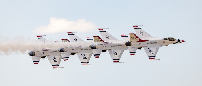 Four aircraft flying in sky.