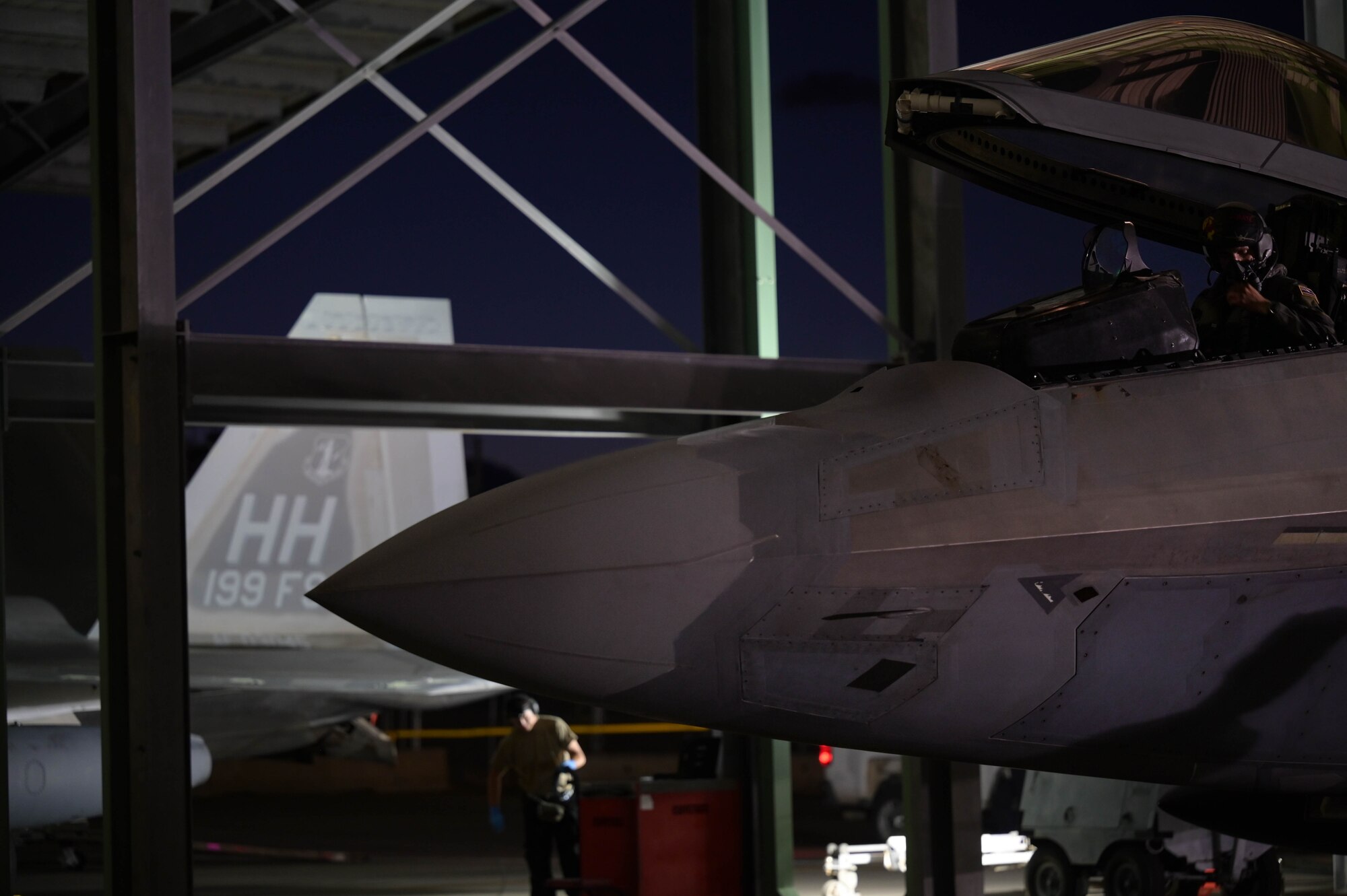 A pilot sitting inside the cockpit of a fighter jet.