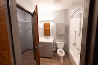 A newly finished view of the walk-in closet and bathroom of new dorm facility.