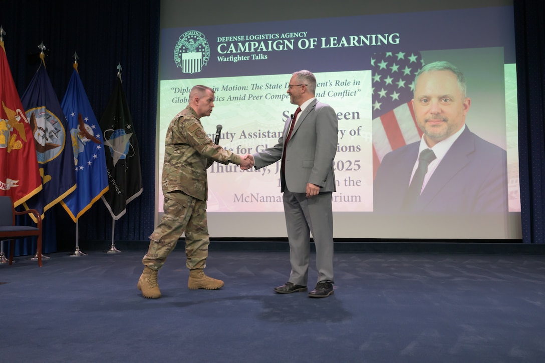 Defense Logistics Agency Director of Logistics Operations Air Force Maj. Gen. David Sanford, left, thanks Deputy Assistant Secretary of State for Global Operations Seth Green at Fort Belvoir, Virginia, July 17, 2025.