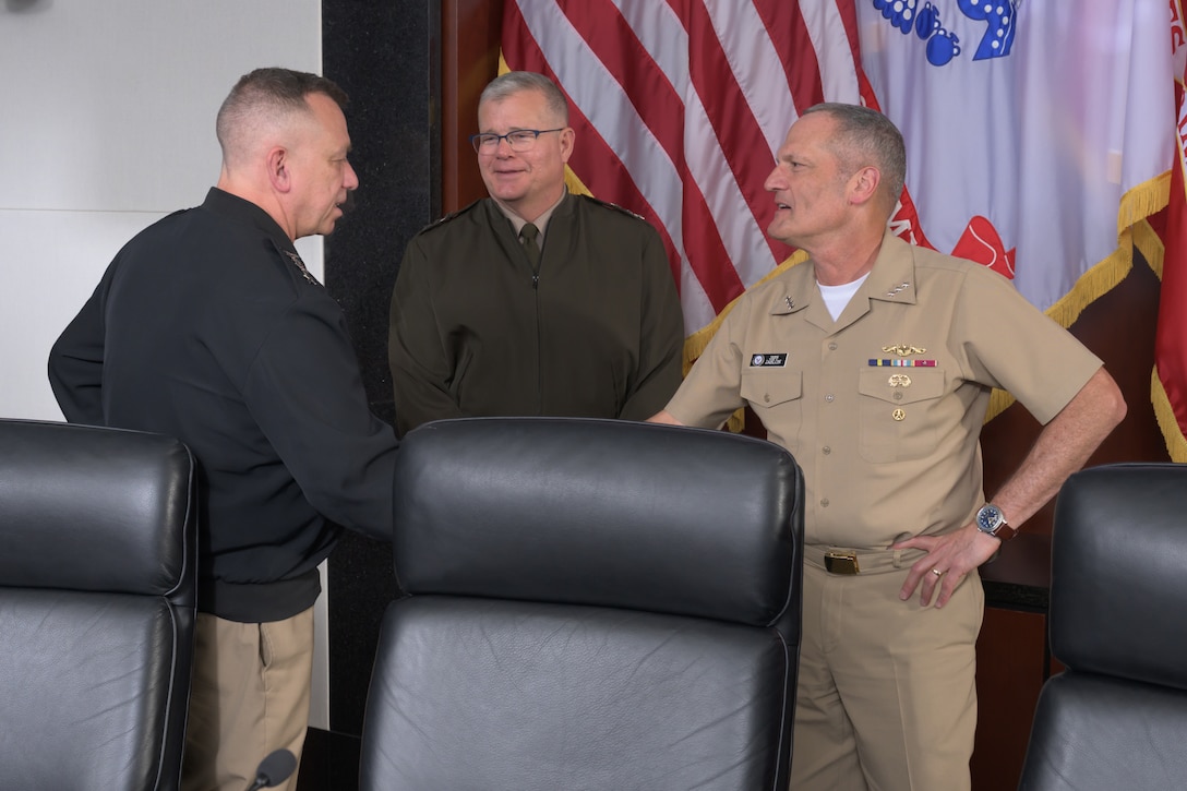 Naval Sea Systems Commander Navy Vice Adm. James Downey, left, Defense Logistics Agency Director Army Lt. Gen. Mark Simerly, center, and Deputy Chief of Naval Operations for Installations and Logistics Navy Vice Adm. Jeffrey Jablon, right, greet each other during the Navy/DLA Service Integration Day in the McNamara Headquarters Complex at Fort Belvoir, Virginia, July 2, 2025.