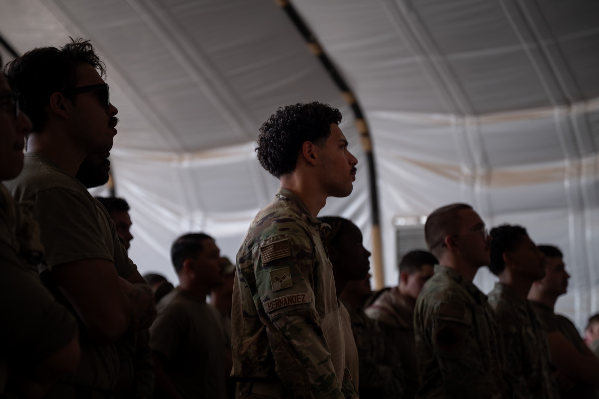 A group of Airmen stand in a crowd