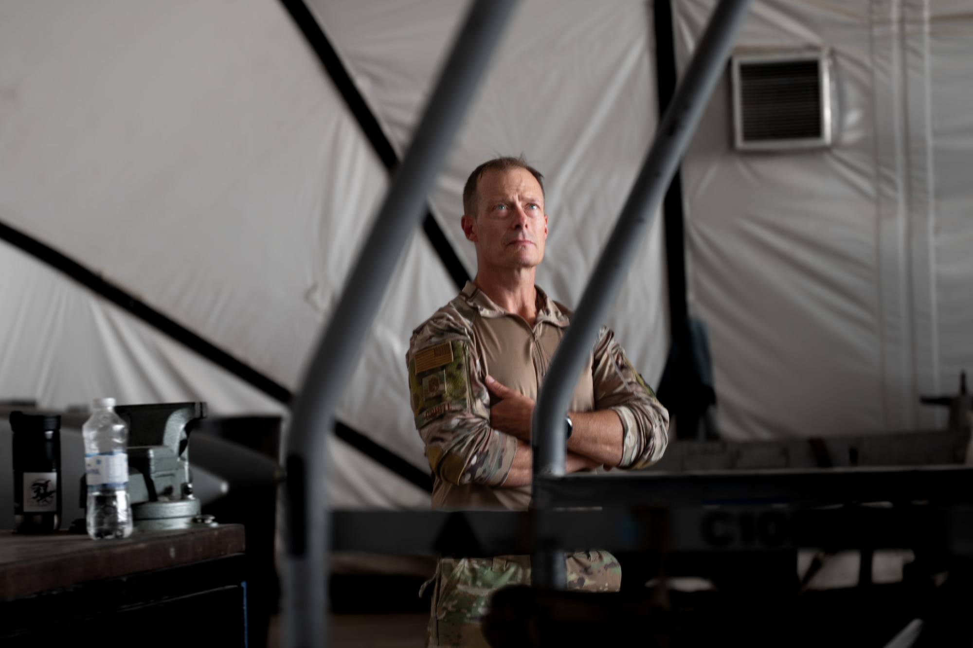 An Airman stands behind a platform