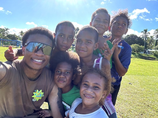 Shared Smiles…Local youngsters of the South Pacific Island nation of Fiji join Hospital Corpsman 2nd Class Shane Durand for an impromptu photo-op. Durand, a Queens, New York native and medical laboratory technician stationed at Naval Hospital Bremerton was part of Pacific Partnership 2025 mission stop to Fiji, June 6-18, 2025. Durand supported efforts at the Fiji Veterinary Pathology Laboratory to help prepare them for accreditation application. Yet there were still opportunities to learn, share, and smile with his hospitable island nation hosts. PP 2025 mission – now in its 21 year - is the largest annual multinational humanitarian assistance and disaster management preparedness mission conducted in the Indo-Pacific (courtesy photo).