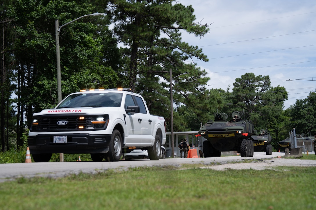 U.S. Marines with 2d Assault Amphibian Battalion, 2d Marine Division, II Marine Expeditionary Force, conduct convoy operations from Morehead City to Camp Lejeune, North Carolina, July 17, 2025. Marines with 2nd Distribution Support Battalion, Combat Logistics Regiment 2, 2nd Marine Logistics Group and 2d AABN, alongside Marines and U.S. Navy Sailors with Whidbey Island-class dock landing ship USS Gunston Hall (LSD 44), Kearsarge Amphibious Ready Group, conducted embarkation and debarkation rehearsals aboard the USS Gunston Hall using the new amphibious combat vehicles. (U.S. Marine Corps photo by Lance Cpl. Javier Santillan)