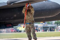 U.S. Air Force Staff Sgt. Brian Westmoreland, 9th Maintenance Squadron aircraft fuel systems repair technician, installs a pogo block onto a U-2 Dragon Lady wing prior to pogo installation at Oshkosh, Wisconsin, July 22, 2025.