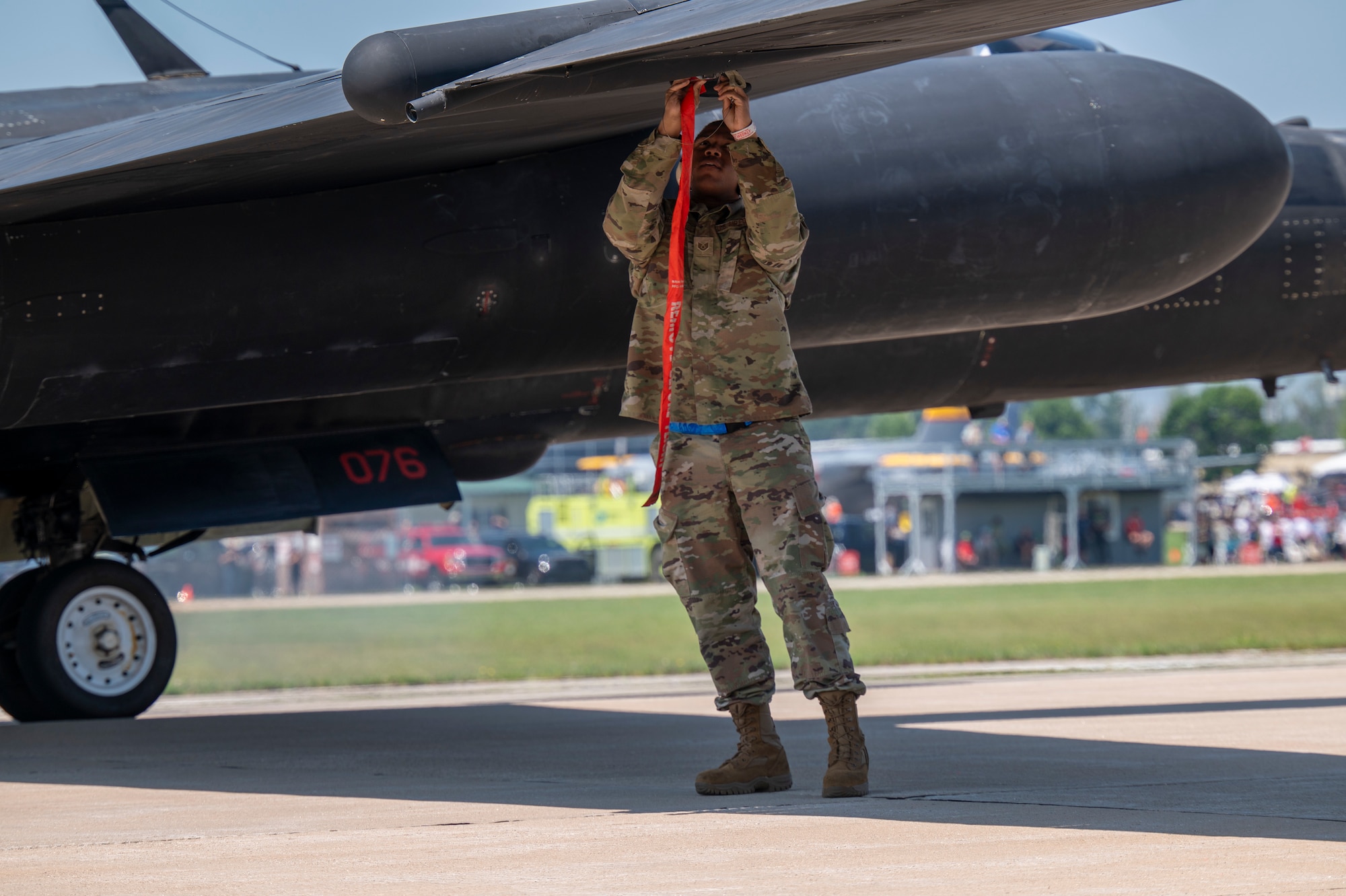 U.S. Air Force Staff Sgt. Brian Westmoreland, 9th Maintenance Squadron aircraft fuel systems repair technician, installs a pogo block onto a U-2 Dragon Lady wing prior to pogo installation at Oshkosh, Wisconsin, July 22, 2025. The pogos are used to support the wings and balance the aircraft while taxiing.