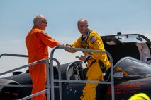 U.S. Air Force Lt. Col. GOGO, 9th Reconnaissance Wing inspector general (right), shakes hands with Jon Huggins, 1st Reconnaissance Squadron U-2 instructor pilot, after successfully landing a U-2 Dragon Lady at Oshkosh, Wisconsin, July 20, 2025