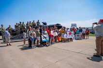 U.S. Air Force Lt. Col. GOGO, 9th Reconnaissance Wing inspector general, poses for a photo with friends, family, and 9 RW Airmen at Oshkosh, Wisconsin, July 20, 2025.