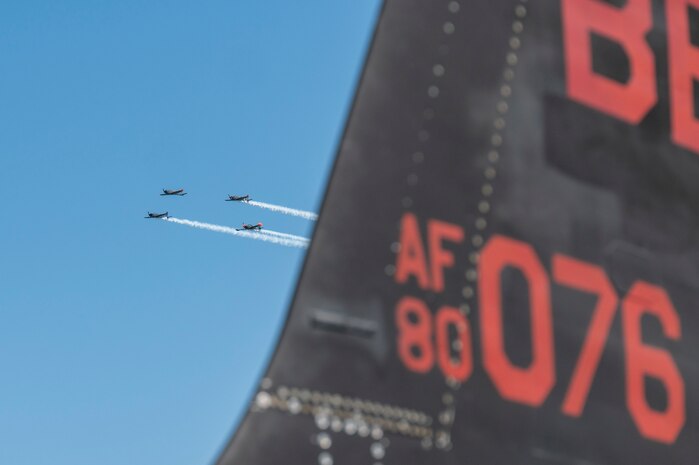 Aerial performers fly behind the tail flash of a U-2 Dragon Lady during Experimental Aircraft Association AirVenture Oshkosh 2025 at Oshkosh, Wisconsin, July 21, 2025