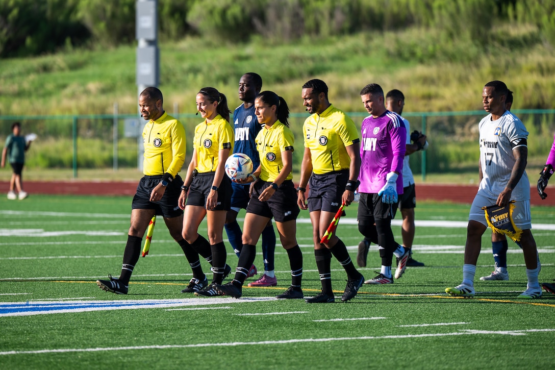 U.S. Navy Sailors (left) and Army Soldiers (right) follow the referees onto the field to start the second match of the Armed Forces Men’s Soccer Championship in Phantom Warrior Stadium, Fort Hood, Texas, on July 28, 2025. Each team faces off in a bracket to determine which service will hold the championship title, featuring teams from the Army, Navy, and Air Force. (U.S. Army photo by Sgt. Tien Dat Ngo)