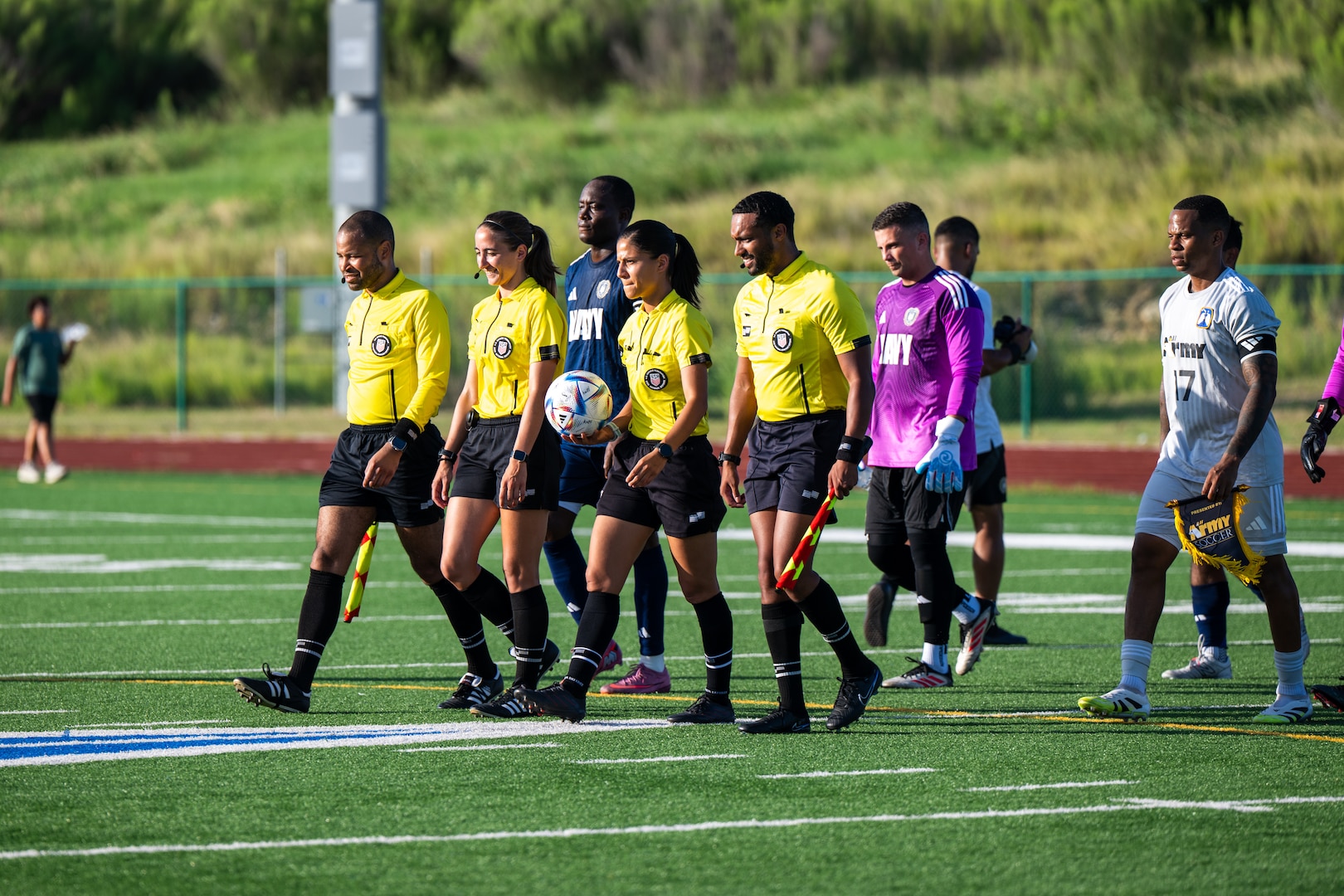 U.S. Navy Sailors (left) and Army Soldiers (right) follow the referees onto the field to start the second match of the Armed Forces Men’s Soccer Championship in Phantom Warrior Stadium, Fort Hood, Texas, on July 28, 2025. Each team faces off in a bracket to determine which service will hold the championship title, featuring teams from the Army, Navy, and Air Force. (U.S. Army photo by Sgt. Tien Dat Ngo)