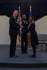 U.S. Air Force Col. Ryan A.F. Crowley, left, commander of Joint Base Anacostia-Bolling and the 11th Wing, receives a crook from Lt. Col. Meoshia Wilson, outgoing senior chaplain of the 11th WG, during a ceremony June 23, 2025.