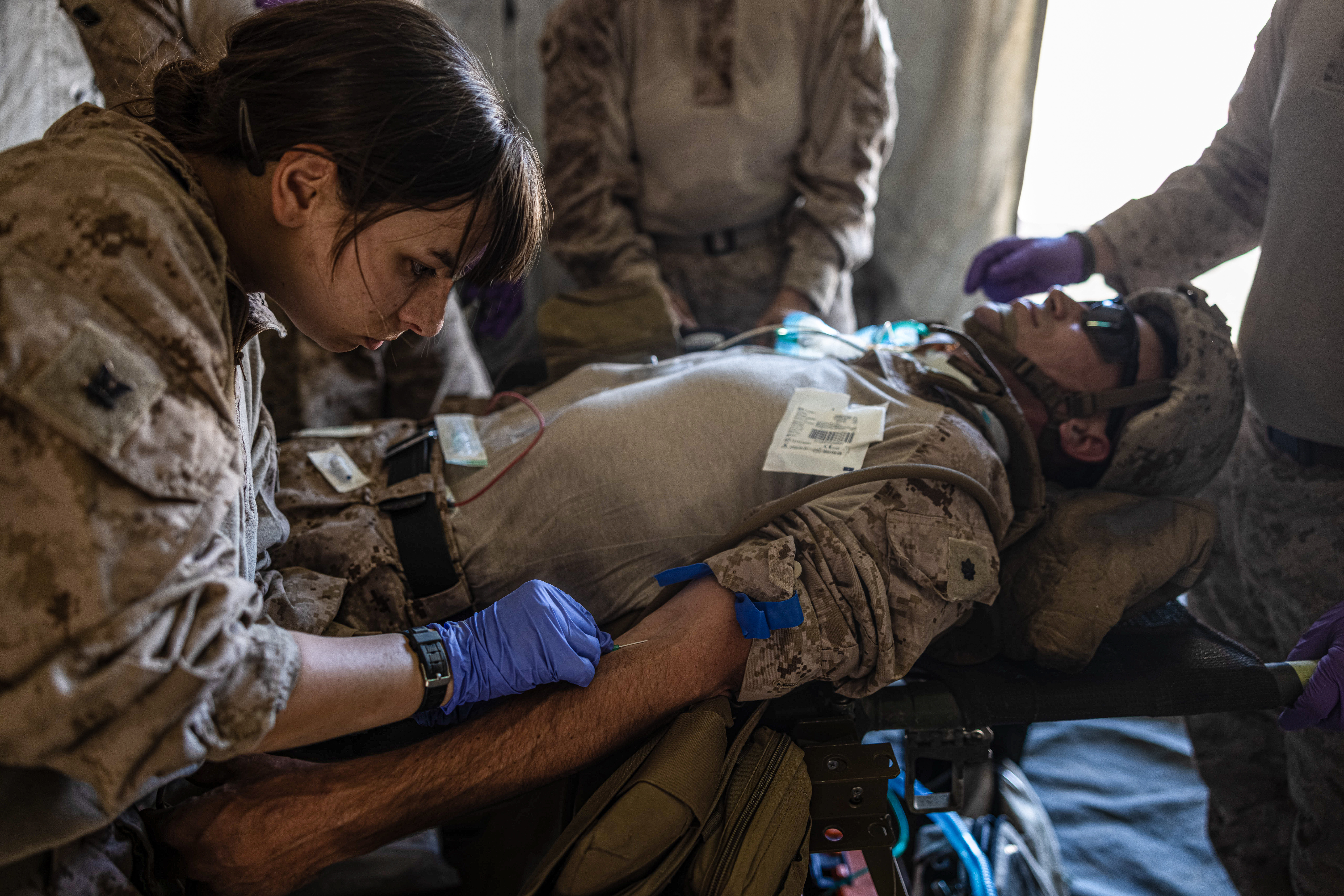 U.S. Navy Hospital Corpsman 3rd Class Madison Cira, a field medical service technician with Combat Logistics Battalion 8, Combat Logistic Regiment 2, 2d Marine Logistics Group, performs a triage as part of damage control resuscitation drills during Service Level Training Exercise 4-25, at Marine Corps Air-Ground Combat Center, Twentynine Palms, California, July 24, 2025. SLTE 4-25 is designed to be a challenging, realistic training environment that produces combat-ready forces capable of operating as an integrated Marine Air Ground Task Force across all domains of military operations. (U.S. Marine Corps photo by Lance Cpl. Judith Ann Lazaro)