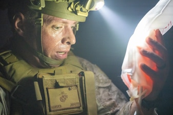 U.S. Navy Hospital Corpsman 1st Class Joshua Harden, an independent duty corpsman with Headquarters Battalion, 2d Marine Division, gives blood to a simulated casualty during a Tier IV Tactical Combat Casualty Care Course at the Battle Skills Training School, Marine Corps Base Camp Lejeune, North Carolina, July 23, 2025.  This was the first-ever Tier IV TCCC hosted by a Marine Corps command and the first course executed by U.S. Navy personnel on the East Coast. The course trains select military service members to become proficient combat paramedics capable of providing advanced casualty care at the point of injury on the battlefield and in austere environments. (U.S. Marine Corps photo by Cpl. Apollo Wilson)