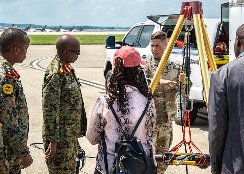 U.S. Army Sgt. Andrew Stratton, center right, logistics non-commissioned officer for the Kentucky National Guard’s Chemical, Biological, Radiological, Nuclear and high-yield Explosives Enhanced Response Force Package, discusses a pulley system used for personnel search and extraction operations with leaders from the Djiboutian armed forces during their visit to the Kentucky Air National Guard Base in Louisville, Ky., July 22, 2025.