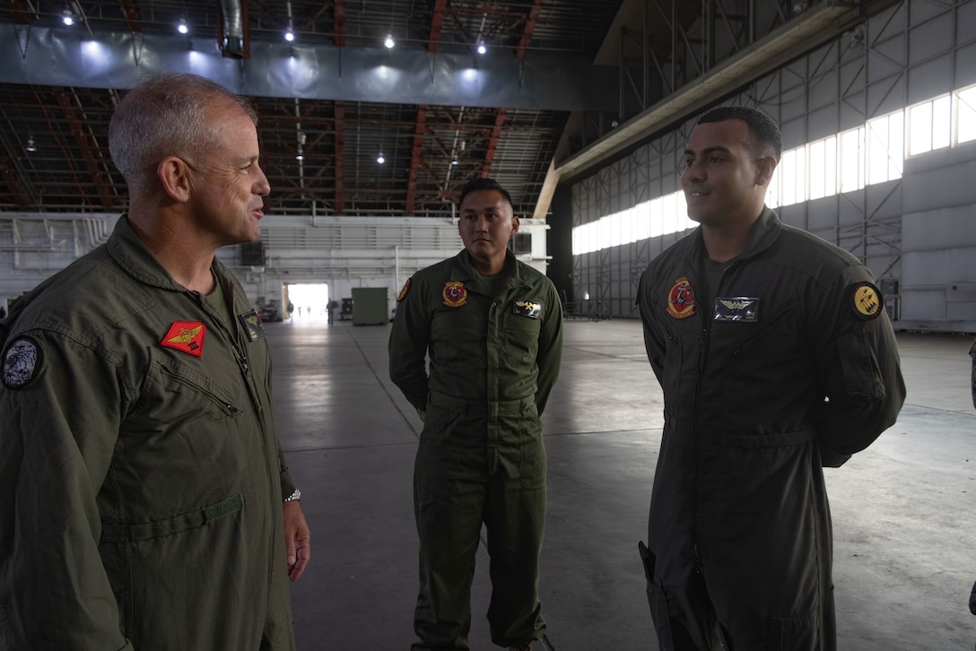 U.S. Marine Corps Maj. Gen. James B. Wellons, commanding general of 3rd Marine Aircraft Wing, recognizes U.S. Marine Corps Sgt. Joseph Ortiz, an airframes mechanic with Marine Fighter Attack Squadron (VFMA) 311, Marine Aircraft Group 11, 3rd MAW, for his outstanding work during Red Flag Alaska 25-2 on Eielson Air Force Base, Alaska, July 24, 2025.