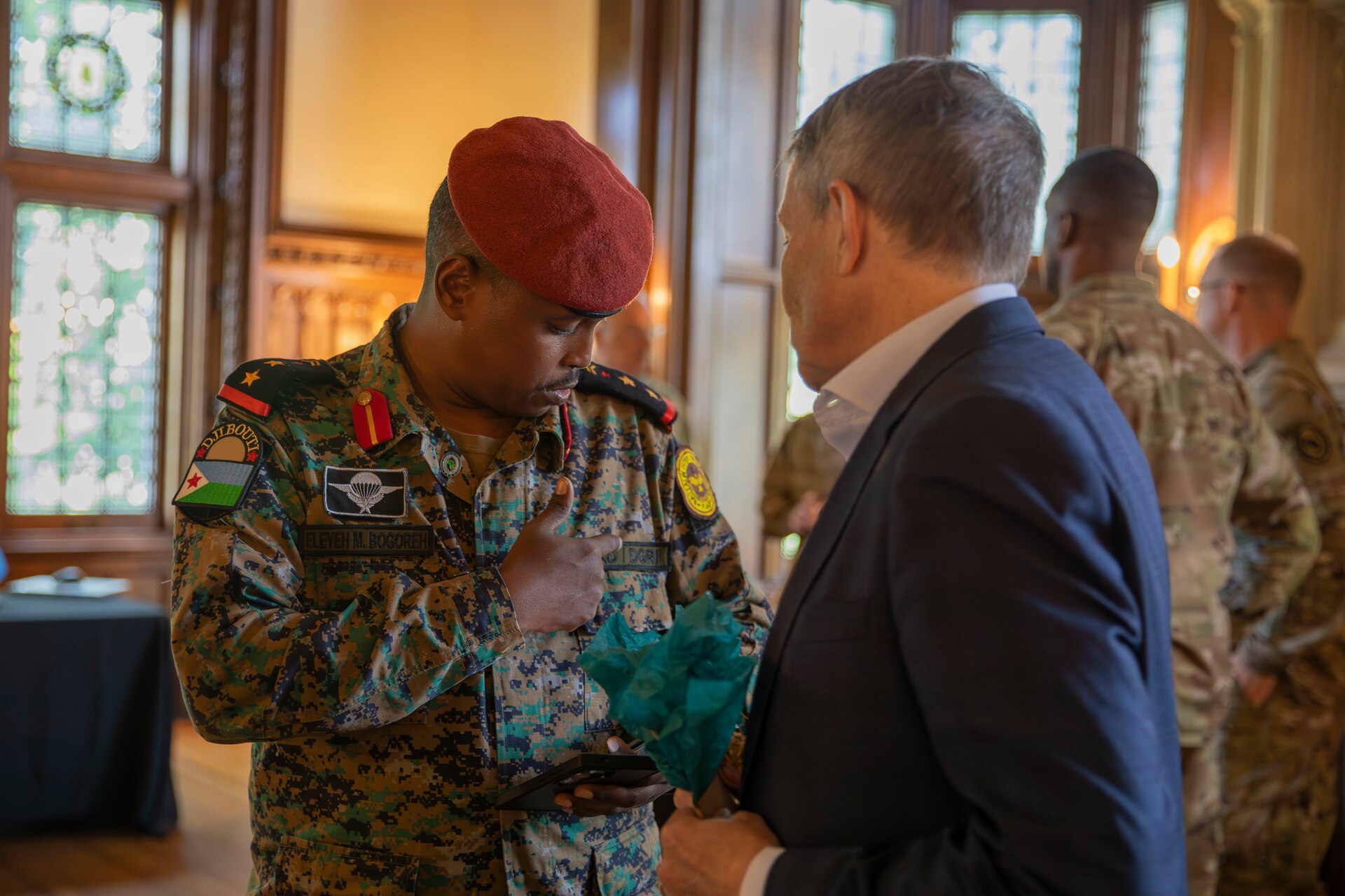 Captain Eleyah Mohamed Bogoreh of the Djiboutian Armed Forces (left) points out a detail on his uniform to Mr. Robert Riley, senior foreign policy advisor to the Chief of the National Guard Bureau, during a key leader engagement in Frankfort, Kentucky, July 23, 2025.
