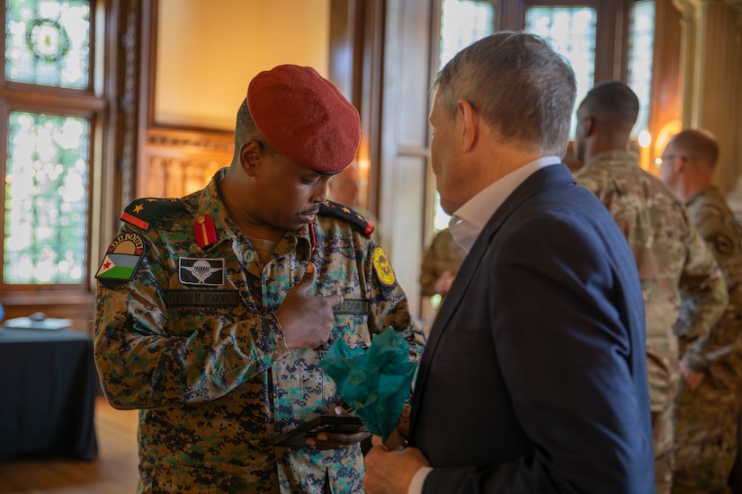 Captain Eleyah Mohamed Bogoreh of the Djiboutian Armed Forces (left) points out a detail on his uniform to Mr. Robert Riley, senior foreign policy advisor to the Chief of the National Guard Bureau, during a key leader engagement in Frankfort, Kentucky, July 23, 2025.