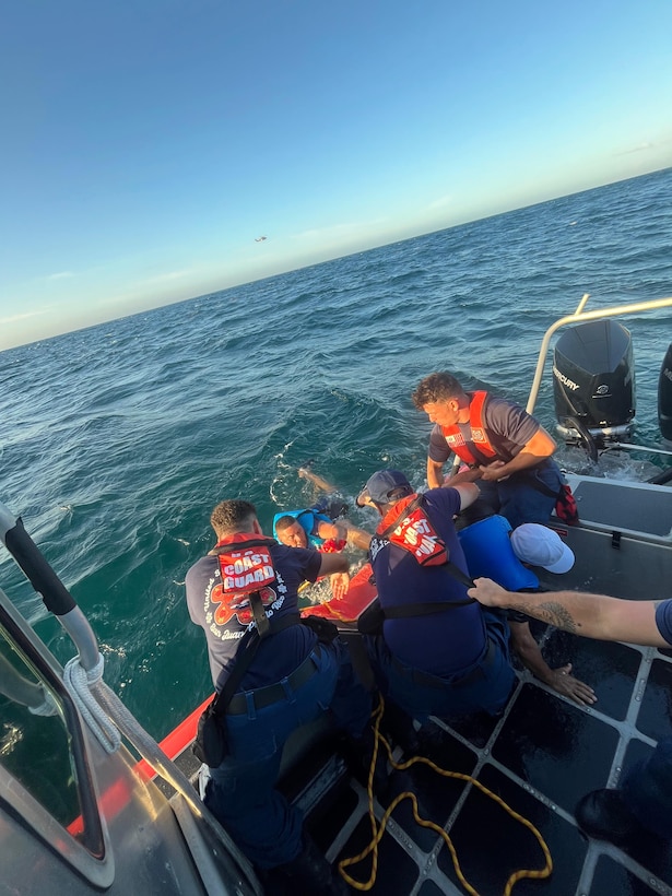 Coast Guard Station San Juan boat crew rescues three boaters from the water after they were forced to abandon their vessel that was taking on a water, approximately one nautical mile north of San Juan Harbor, July 28, 2025.  The Coast Guard boat crew worked with a Puerto Rico Police Marine unit to bring the boaters and the distressed vessel to safe harbor. (U.S. Coast Guard photo)