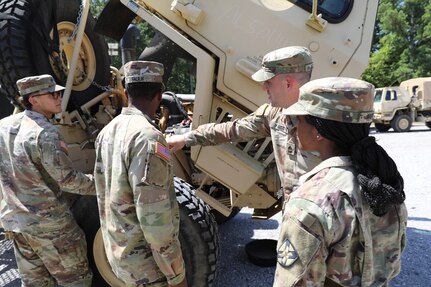 Sgt. 1st Class Jonathon Kilgo, Pfc. Orlandria Harris and Spc. Jayden Faulk, all motor transport operators with the 1670th Transportation Company, conduct preventive maintenance checks and services (PMCS) during their annual training at Fort McClellan, Alabama, on July 13, 2025.