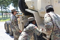 Pfc. Orlandria Harris and Spc. Jayden Faulk conducts preventive maintenance checks and services (PMCS) as their unit, the 1670th Transportation Company, prepares for a multi-state convoy as part of Operation Patriot Press on July 13, 2025.