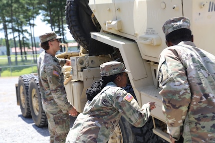 Pfc. Orlandria Harris and Spc. Jayden Faulk conducts preventive maintenance checks and services (PMCS) as their unit, the 1670th Transportation Company, prepares for a multi-state convoy as part of Operation Patriot Press on July 13, 2025.