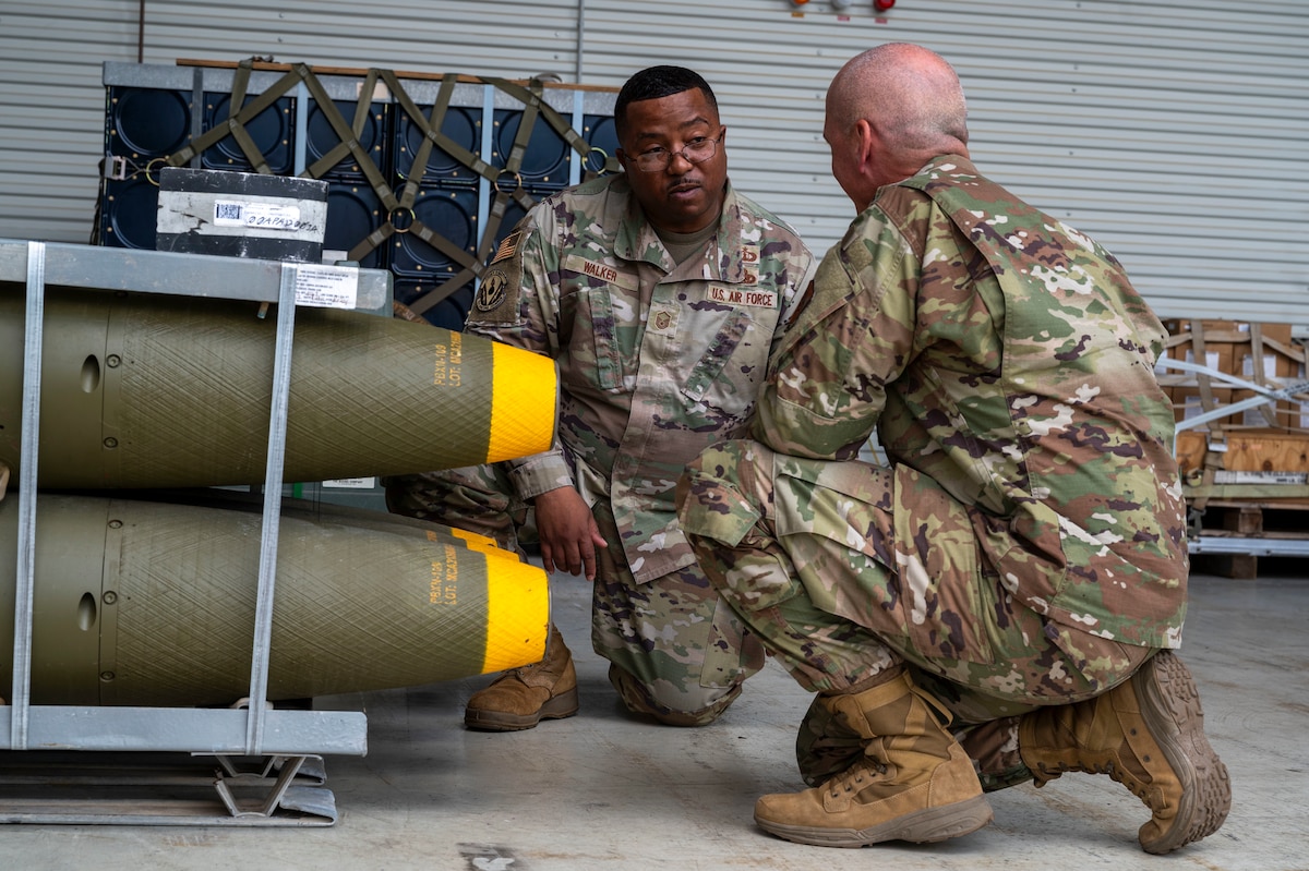 Chief Master Sergeant of the Air Force David A. Flosi speaks with Master Sgt. Eeshjunn Walker about munitions during Flosi’s visit to Ramstein Air Base, Germany, July 23, 2025. Flosi engaged with Airmen advancing Department of Defense priorities through their execution of United States Air Forces in Europe – Air Forces Africa, 86th Airlift Wing and 435th Air Ground Operations Wing missions. (U.S. Air Force photo by Senior Airman Sabrina Fuller-Judd)