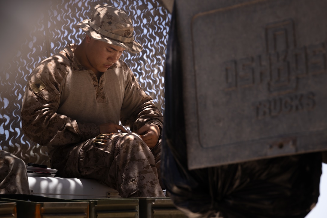 U.S. Marine Corps Cpl. Evest Shee, an ammunition technician with Combat Logistics Battalion 25, 4th Marine Logistics Group, loads ammunition at Integrated Training Exercise 3-25 (ITX 3-25) at Marine Corps Air Ground Combat Center, Twentynine Palms, California, June 10th, 2025. ITX enhances Marines’ lethality by empowering leaders at every level to adapt, communicate, and execute dynamic movements in hostile environments. (U.S. Marine Corps photo by Lance Cpl. Edward Spears)