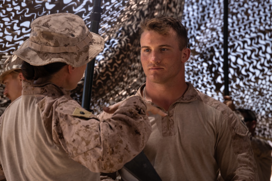 U.S. Marine Corps Lt. Col. Carina Cuellar (left), battalion commander of 4th Law Enforcement Battalion, Force Headquarter Group, speaks with Staff Sgt. Nick Johnson, a squad leader in 4th Law Enforcement Battalion, Force Headquarters Group, at Integrated Training Exercise 3-25 (ITX 3-25) at Marine Corps Air Ground Combat Center, Twentynine Palms, California, June 10th, 2025. ITX enhances Marines’ lethality by empowering leaders at every level to adapt, communicate, and execute dynamic movements in hostile environments. (U.S. Marine Corps photo by Lance Cpl. Edward Spears)