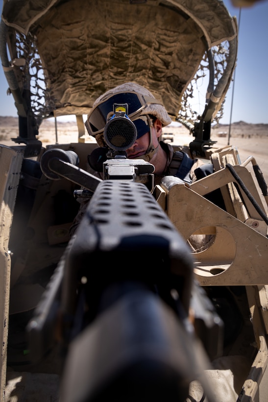 U.S. Marine Corps Cpl. Braedyn Nadzam, a military police officer with 4th Law Enforcement Battalion, Force Headquarters Group, sights into an M240 machine gun at Integrated Training Exercise 3-25 (ITX 3-25) at Marine Corps Air Ground Combat Center, Twentynine Palms, California, June 10th, 2025. ITX is a critical Marine Air-Ground Task Force exercise for the Marine Forces Reserve’s training cycle, confirming unit readiness through live-fire and combined arms integration. (U.S. Marine Corps photo by Lance Cpl. Edward Spears)