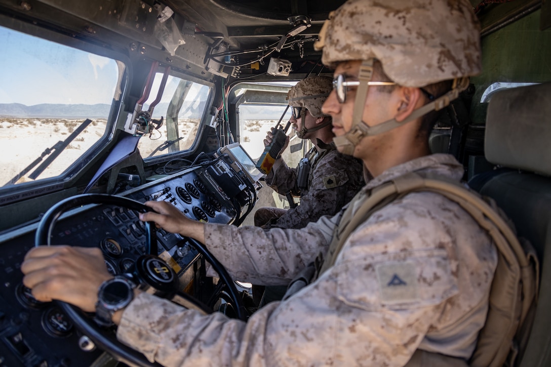 U.S. Marine Corps LCpl. Jesus Fuentes (left), a motor transport operator, and Cpl. Logan Smith, a fire team leader, both with 4th Law Enforcement Battalion, Force Headquarters Group, operate a medium tactical vehicle replacement during Integrated Training Exercise 3-25 (ITX 3-25) at Marine Corps Air Ground Combat Center, Twentynine Palms, California, June 10th, 2025. ITX enhances Marines’ lethality by empowering leaders at every level to adapt, communicate, and execute dynamic movements in hostile environments. (U.S. Marine Corps photo by Lance Cpl. Edward Spears)