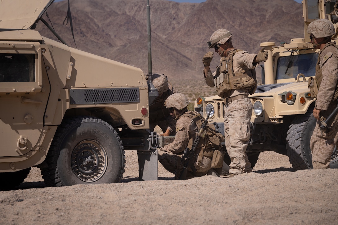 U.S. Marines with the 4th Law Enforcement Battalion, Force Headquarters Group connect a tow hitch to a Humvee at Integrated Training Exercise 3-25 (ITX 3-25) at Marine Corps Air Ground Combat Center, Twentynine Palms, California, June 10th, 2025. ITX is a critical Marine Air-Ground Task Force exercise for the Marine Forces Reserve’s training cycle, confirming unit readiness through live-fire and combined arms integration. (U.S. Marine Corps photo by Lance Cpl. Edward Spears)