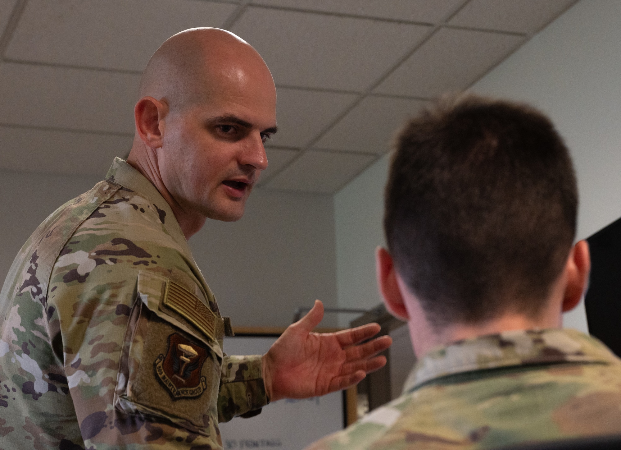 U.S. Air Force Maj. Bruce Vonniederhausern, 509th Maintenance Group research engineering chief engineer, helps an ROTC cadet with a project during an internship at Whiteman Air Force Base, Missouri, July 17, 2025. The internship allowed cadets to experience a military work environment while also granting the chance to gain knowledge outside the classroom. (U.S. Air Force photo by Senior Airman Joseph Garcia)