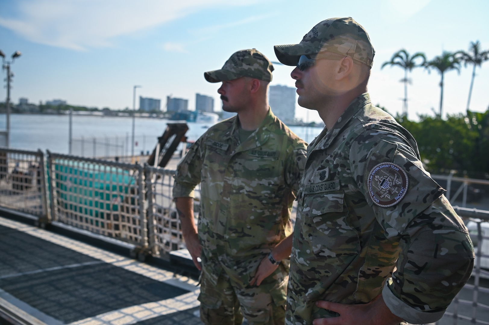 Coast Guard Tactical Law Enforcement Team - Pacific members watching over interdicted contraband at Port Everglades, Florida, July 29, 2025. Tactical law enforcement teams deploy aboard Coast Guard Cutters on drug interdiction missions to provide operational support. (U.S. Coast Guard photo by Petty Officer 3rd Class Nicholas Strasburg)