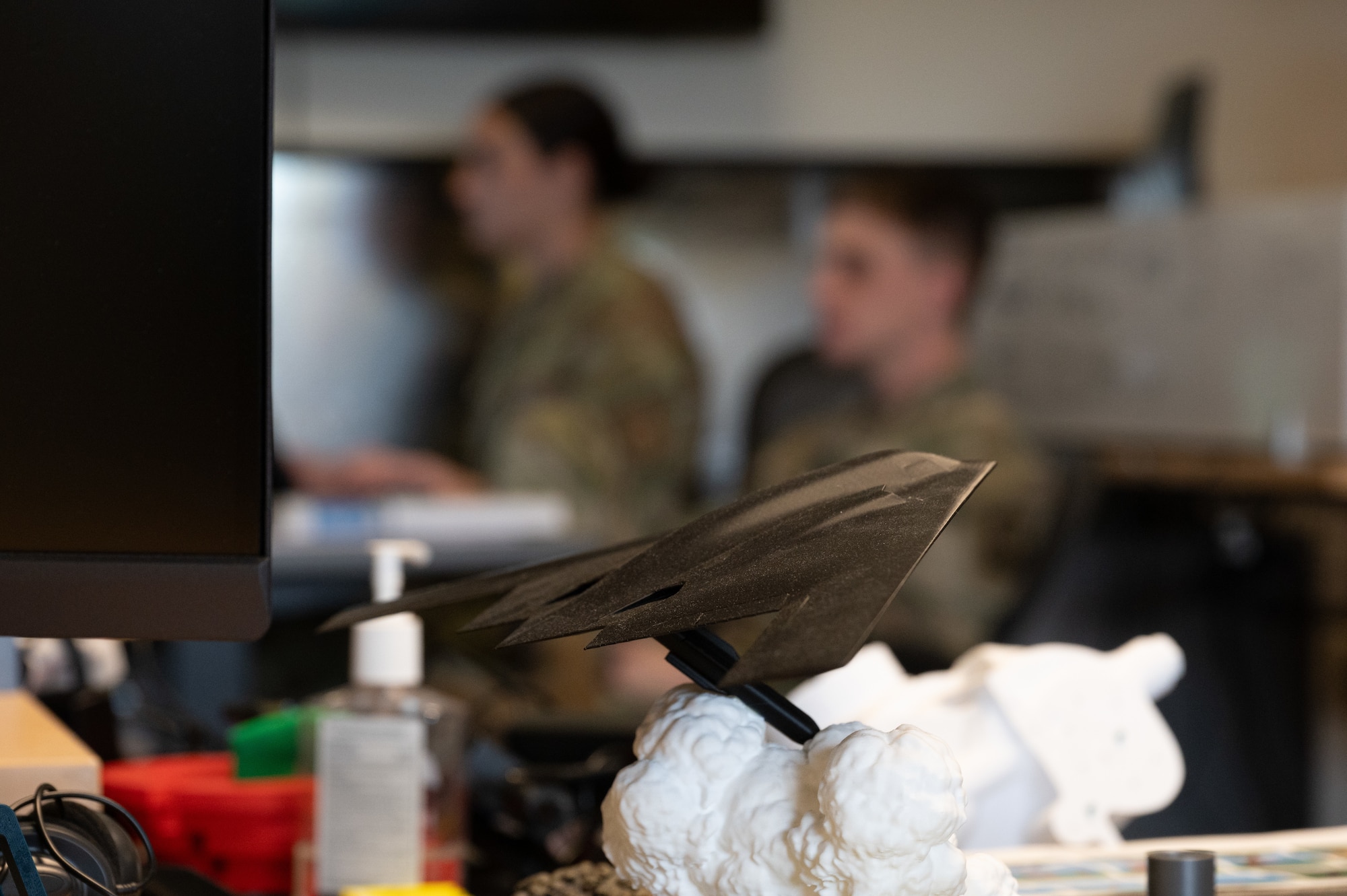 U.S. Air Force cadets from various college ROTC programs work on a project during an internship program in the background at Whiteman Air Force Base, Missouri, July 17, 2025. Cadets got hands-on experience to further their education in an operational environment to help develop skills for their future careers. (U.S. Air Force photo by Senior Airman Joseph Garcia)