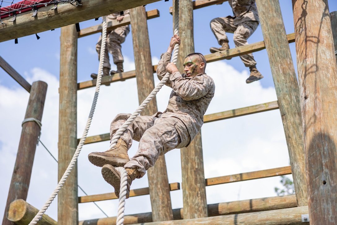 A U.S. Marine Corps officer candidate navigates an obstacle on the Confidence Course during the Forge at Officer Candidate School, on Marine Corps Base Quantico, Virginia, July 23, 2025. The Forge is a culminating event designed to test candidates’ endurance, leadership and resilience under pressure involving day and night hikes, simulated indirect fire, sleep deprivation, obstacle navigation and team-based exercises. (U.S. Marine Corps photo by Sgt. Dean Gurule)