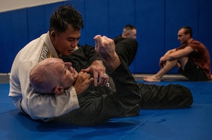 A man chokes another man.
