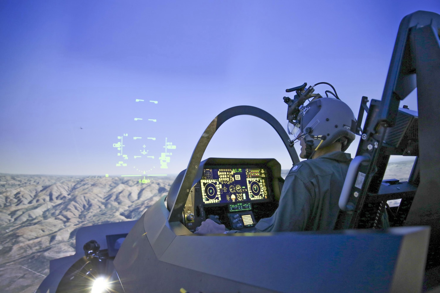 A pilot trains in the Joint Simulation Environment (JSE) at the Naval Air Warfare Center Aircraft Division in Patuxent River, Maryland. Tactical pilots from the Marine Corps and Air Force conducted the first-ever joint training exercise flying simulated combat missions together in F-35 and F-22 fifth-generation fighter jets in the JSE on March 24-27.