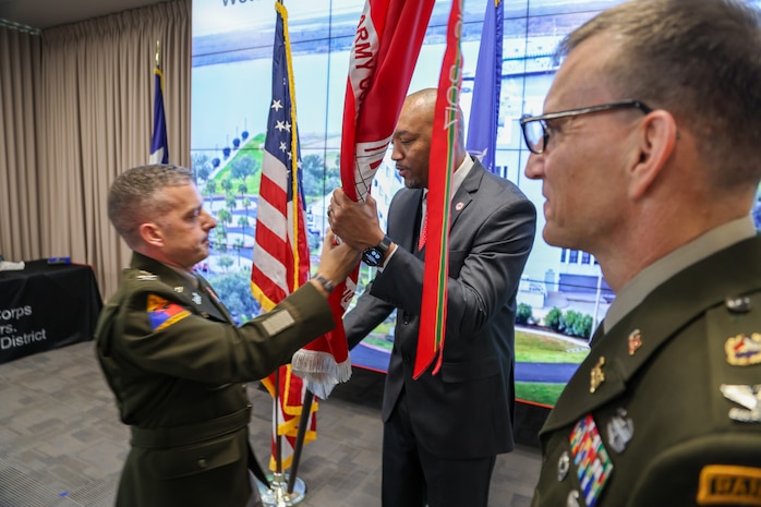 Incoming U.S. Army Corps of Engineers (USACE) Galveston District Commander Col. David W. Dake (left) passes the district's colors to Galveston Districts Deputy District Engineer Byron Williams (center) during a change of command ceremony, July 29, 2025.

During USACE change of command ceremonies, the passing of the colors from the incoming commander to the senior civilian signifies the confidence that the commander places in the civilian work force to accomplish the mission. 

Dake assumed command from Col. Rhett A. Blackmon (right), who also retired after 26 years of active-duty service. 

U.S. Army photo by Luke Waack