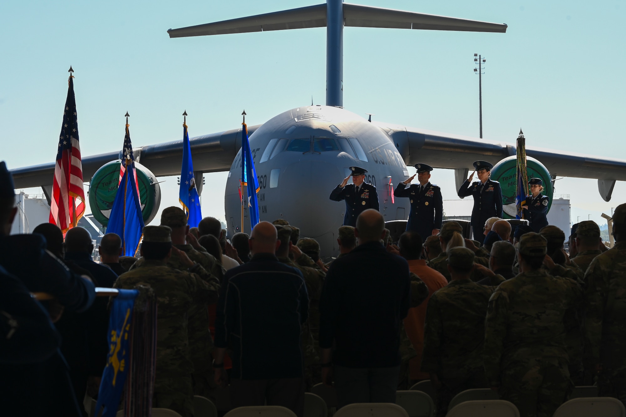 From left, U.S. Air Force Maj. Gen. Charles Bolton, Eighteenth Air Force commander, Col. Sergio Anaya, outgoing 62d Airlift Wing commander, and Col. Jessica Regni, incoming 62d AW commander, render a salute to the flag during the presentation of colors at the 62d AW change of command ceremony at Joint Base Lewis-McChord, Washington, July 29, 2025.