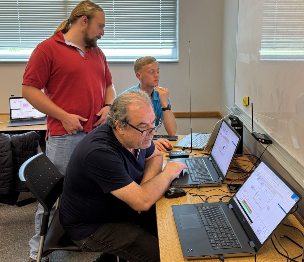 Side profile of participants sitting in front of laptop computers.