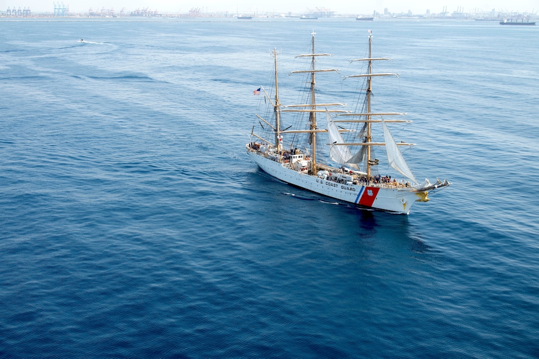 The U.S. Coast Guard Cutter Eagle, seen from inside a Coast Guard MH-60T Jayhawk helicopter, departs Los Angeles Harbor on May 26, 2025. The Coast Guard uses the Eagle to train cadets and officer candidates, teaching them practical seamanship skills while indoctrinating them in the Coast Guard’s afloat leadership laboratory. The Eagle moored for Los Angeles Fleet Week 2025, where cadets led public tours of the ship and participated in morale events with other branches of the military to reinforce teamwork. (Coast Guard photo by Petty Officer First Class J.J. Huggins)