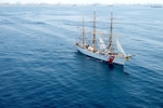 The U.S. Coast Guard Cutter Eagle, seen from inside a Coast Guard MH-60T Jayhawk helicopter, departs Los Angeles Harbor on May 26, 2025. The Coast Guard uses the Eagle to train cadets and officer candidates, teaching them practical seamanship skills while indoctrinating them in the Coast Guard’s afloat leadership laboratory. The Eagle moored for Los Angeles Fleet Week 2025, where cadets led public tours of the ship and participated in morale events with other branches of the military to reinforce teamwork. (Coast Guard photo by Petty Officer First Class J.J. Huggins)
