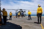 Sailors assigned to the amphibious assault ship USS Wasp (LHD 1) facilitate deck landing qualifications for an MH-53E Sea Dragon, assigned to the “Blackhawks” of Helicopter Mines Countermeasures Squadron 15 (HM-15), on the ship’s flight deck, April 5, 2025. Wasp is underway conducting routine operations in the Atlantic Ocean.