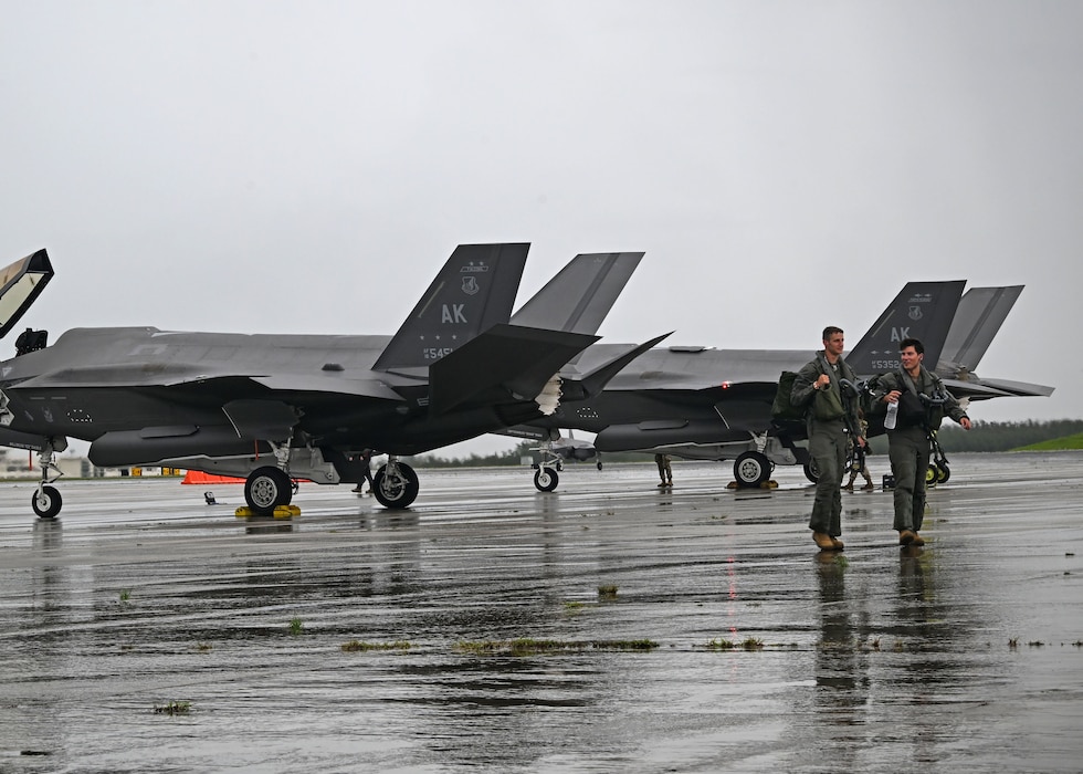 U.S. Air Force Capt. Joseph “BANG” Scholl left, and Capt. Nick “Arson” Bohrer, 355th Mission Generation Force Element F-35A Lightning II pilots, arrive in Guam for exercise Resolute Force Pacific 25 in Guam, July 12, 2025.