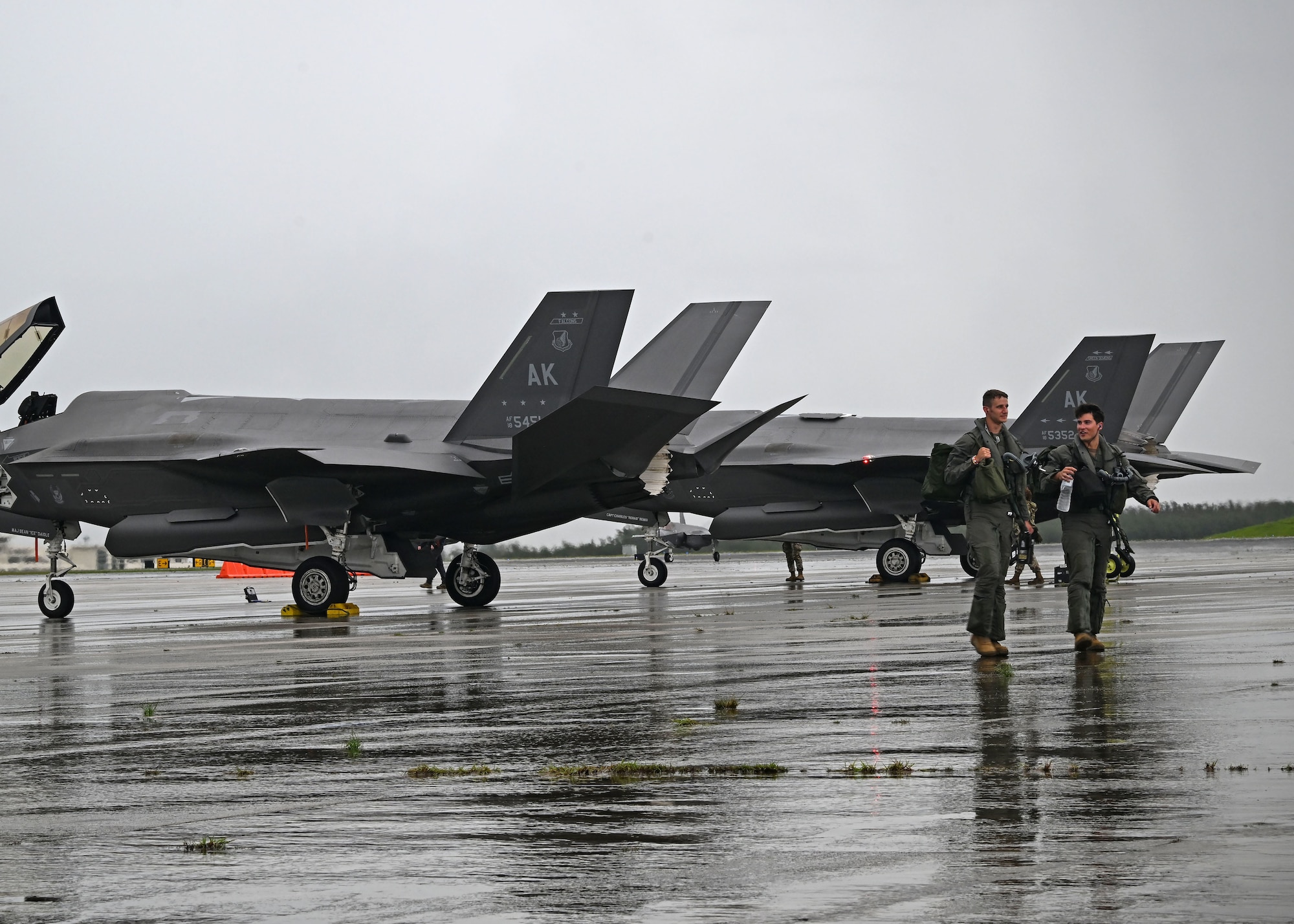 U.S. Air Force Capt. Joseph “BANG” Scholl left, and Capt. Nick “Arson” Bohrer, 355th Mission Generation Force Element F-35A Lightning II pilots, arrive in Guam for exercise Resolute Force Pacific 25 in Guam, July 12, 2025.