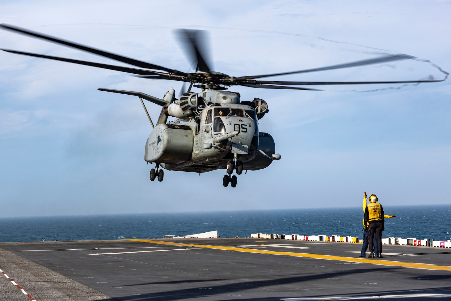 Aviation Boatswain’s Mate (Handling) Airman Miguel Martinez, assigned to the amphibious assault ship USS Wasp (LHD 1), prepares to chock and chain an MH-53E Sea Dragon, assigned to the “Blackhawks” of Helicopter Mines Countermeasures Squadron 15 (HM-15), on the ship’s flight deck, April 5, 2025. Wasp is underway conducting routine operations in the Atlantic Ocean.